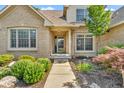 Inviting home entrance with a charming brick facade, well-maintained landscaping, and a welcoming walkway at 6686 Woodcrest Dr, Avon, IN 46123