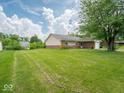 Spacious lawn highlights this single story ranch home with brick and vinyl exterior and attached garage at 7645 Inverness Dr, Indianapolis, IN 46237