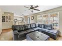 Comfortable living room area showcasing a large window, open access to the kitchen, and a black leather sectional sofa at 787 West St, Whiteland, IN 46184
