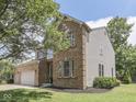 Charming two-story brick home featuring an attached two-car garage and well-maintained landscaping at 8415 Alcona Dr, Indianapolis, IN 46237