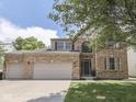 Charming two-story brick home featuring an attached two-car garage and well-maintained landscaping at 8415 Alcona Dr, Indianapolis, IN 46237