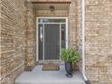 A welcoming front entrance features a classic door and potted fern, inviting guests inside at 8415 Alcona Dr, Indianapolis, IN 46237