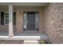 Close-up of the front door, framed by brick and sidelights, providing a grand entrance to the home at 8578 Nolan Dr, Fishers, IN 46038