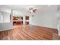 Open-concept living area with hardwood floors, seamlessly connecting to the kitchen with abundant natural light at 8578 Nolan Dr, Fishers, IN 46038