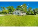 Expansive lawn and charming home featuring mature shade trees and a well manicured yard at 901 N Greenbriar Rd, Muncie, IN 47304