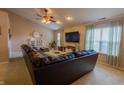 Bright living room with large windows and a comfortable sectional, creating an inviting space at 939 Arabian Way, Bargersville, IN 46106