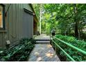 Inviting exterior pathway with a wooden walkway and lush greenery, leading to the home at 944 Briar Patch Ln, Greenwood, IN 46142