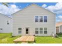 The backyard features a small wooden deck and a grassy lawn at 951 Curlew Ln, Greenwood, IN 46143