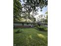 A charming home with a well-maintained lawn surrounded by mature trees at 9550 N Delaware St, Indianapolis, IN 46240