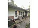 A front entrance with white door and small covered concrete porch at 9550 N Delaware St, Indianapolis, IN 46240