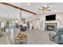 Bright living room features a fireplace, wood beam, open floorplan, and hardwood flooring at 10174 N County Road 471 E, Pittsboro, IN 46167