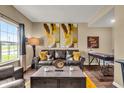 Cozy living room featuring a comfortable leather sofa, stylish decor, and a bright window view at 10917 Hunter Lake Ln, Indianapolis, IN 46239