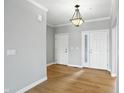 Bright entryway featuring light gray walls, light hardwood floors, and classic pendant lighting at 1127 Kay Dr, Greenwood, IN 46142