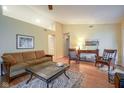 Bright living room with vaulted ceilings, neutral paint, wood floors, and cozy furnishings at 11624 Buttonwood Dr, Carmel, IN 46033