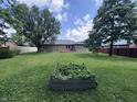 Spacious backyard with mature trees and lush green lawn at 1206 Brownswood Dr, Brownsburg, IN 46112