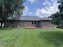 Expansive backyard featuring lush lawn and a wood deck at 1206 Brownswood Dr, Brownsburg, IN 46112