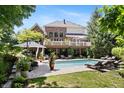 Gorgeous backyard featuring an in-ground pool, lounge chairs, and patio seating at 14027 Waterway Blvd, Fishers, IN 46040