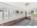 Enclosed porch featuring multi-pane windows, classic brick accents, and an indoor-outdoor feel at 2020 N B St, Elwood, IN 46036