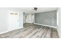 Inviting living room features new flooring, a ceiling fan, and a stylish accent wall at 2136 Ringgold Ave, Indianapolis, IN 46203