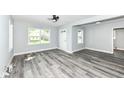 Bright living room with sleek flooring, fresh paint, ceiling fan, and natural light from large windows at 2136 Ringgold Ave, Indianapolis, IN 46203