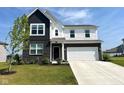 Two-story home featuring a brick and siding exterior, well-manicured lawn, and a two-car garage at 2232 Warbler St, Danville, IN 46122