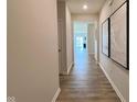 Entry hallway with wood flooring and neutral walls leading into the rest of the house at 2232 Warbler St, Danville, IN 46122