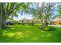 Charming one-story home with well-manicured lawn, mature shade trees, and garden at 317 Stoner Dr, Anderson, IN 46013