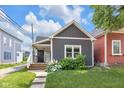 Charming home with a well-maintained lawn and a welcoming front porch at 329 Parkway Ave, Indianapolis, IN 46225