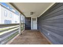 Covered front porch with wood flooring and white railings at 329 Parkway Ave, Indianapolis, IN 46225