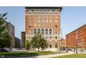 Brick building with arched windows surrounded by green trees and a well-manicured lawn at 350 N Meridian St # 606/607, Indianapolis, IN 46204