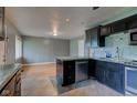 Bright kitchen featuring sleek black cabinetry, modern appliances, and stylish tile flooring at 3513 Ireland Dr, Indianapolis, IN 46235