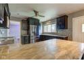 Open concept kitchen with a large island, stainless steel appliances, and decorative tiled backsplash at 3513 Ireland Dr, Indianapolis, IN 46235