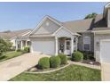 Home exterior with a brick facade, attached garage, and landscaped lawn, blending curb appeal and functionality at 3962 Kristi Way, Greenwood, IN 46142