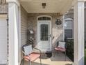 Inviting front porch with seating, a decorative door, and brick accents, offering a warm welcome at 3962 Kristi Way, Greenwood, IN 46142