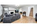 Spacious living room with hardwood floors, fireplace, and staircase access at 5144 N College Ave, Indianapolis, IN 46205
