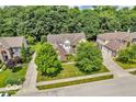 An aerial view of a home situated on a lot with mature trees and professional landscaping at 5865 Osage Dr, Carmel, IN 46033