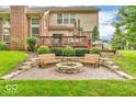 Landscaped backyard with paver patio, fire pit and stone benches, perfect for entertaining at 5865 Osage Dr, Carmel, IN 46033