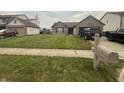 Traditional home featuring a neat lawn and a mailbox, set in a quiet neighborhood at 5954 Honeywell Dr, Indianapolis, IN 46236
