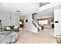 Spacious living room with fireplace, neutral tones, carpeted floor, and open floor plan provides space to gather at 6126 Navy Cir, Indianapolis, IN 46221