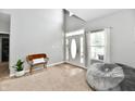 Bright living room features neutral tones, carpeted floor, vaulted ceiling, front door and large windows at 6126 Navy Cir, Indianapolis, IN 46221