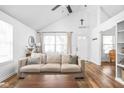 Bright living room with vaulted ceiling, hardwood floors, and neutral decor with a cozy couch at 6142 Evanston Ave, Indianapolis, IN 46220