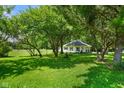 Beautiful home with a large, lush lawn, mature trees and landscaping at 6208 S 200 W, Trafalgar, IN 46181