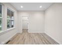 Bright bedroom features wood-look floors, neutral paint, large window, and a door to the walk-in closet at 6553 Stone Pointe Way, Indianapolis, IN 46237