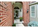 Charming front porch featuring an arched doorway, a potted plant, and a cozy seating area at 6570 Freemont Ln, Carmel, IN 46033