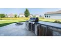 Outdoor kitchen featuring a built-in grill, countertop space, and fire pit at 6664 Kara Ln, Brownsburg, IN 46112