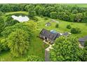 Aerial view of the property featuring a pool, pond, and various outbuildings at 750 N 500 W, Lebanon, IN 46052