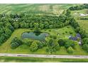 A captivating aerial view of the property, showcasing a pond and sprawling green landscape at 750 N 500 W, Lebanon, IN 46052
