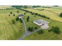 Expansive aerial view of the property, highlighting the well-maintained home, lush greenery, and outbuilding at 7702 N County Road 300 W, Lizton, IN 46149