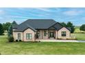 Charming brick home with manicured lawn and mature trees, offering a picturesque and welcoming curb appeal at 7702 N County Road 300 W, Lizton, IN 46149
