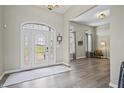 Elegant foyer with hardwood floors and decorative glass front door, offering a grand entrance and welcoming ambiance at 7702 N County Road 300 W, Lizton, IN 46149
